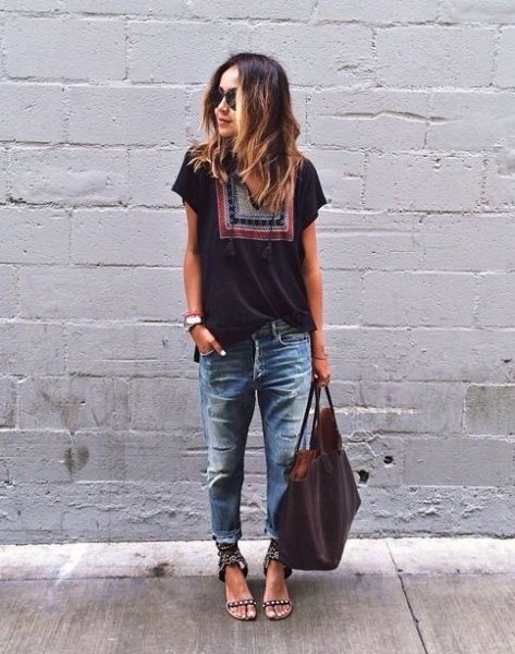 black t-shirt with tribal print with heavily ripped and washed boyfriend jeans