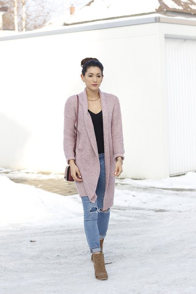 pink cardigan with black v-neck and ripped jeans