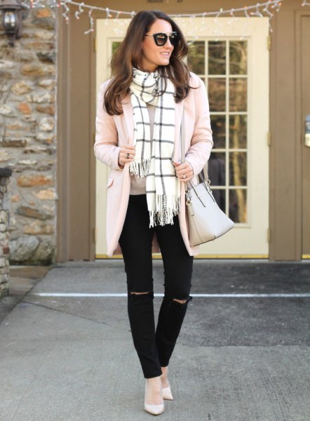 Light pink cardigan with a white and black checked scarf with fringes