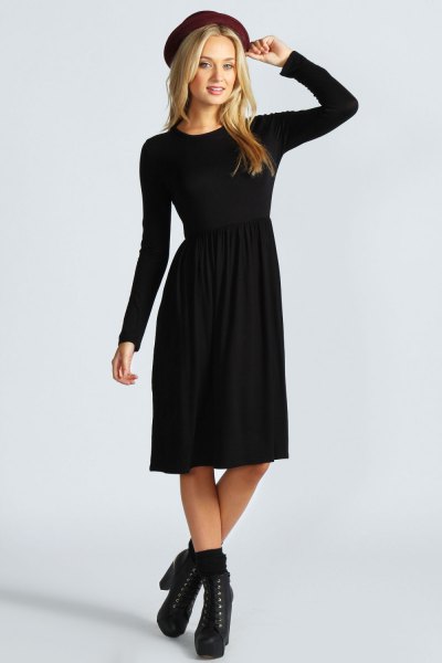 Black long sleeve fitted felt hat and flared midi dress with heeled boots