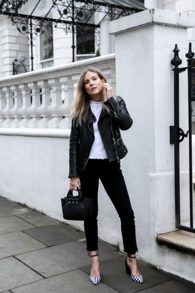 black moto jacket with high rise jeans and plaid heels