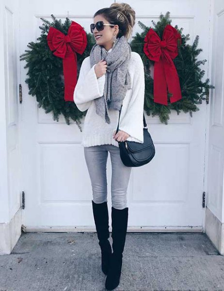 white chunky knit sweater with gray skinny jeans and black knee high tall boots