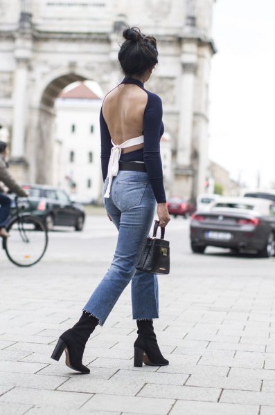 black backless long sleeve top with blue slim fit ankle jeans