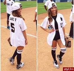 white oversized baseball jersey shirt with black crop top and mini jean shorts
