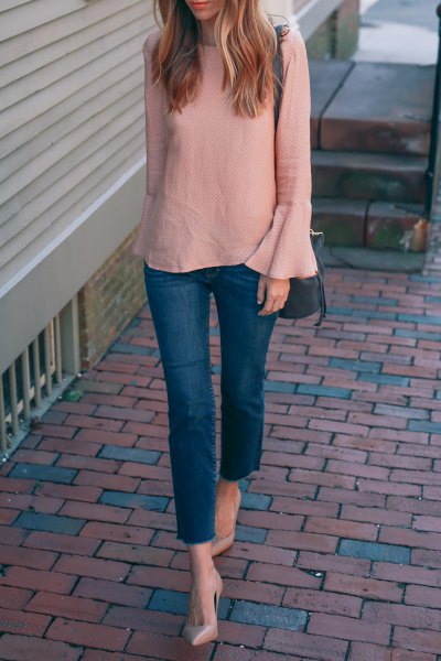 blush pink chiffon blouse with bell sleeves and blue skinny jeans