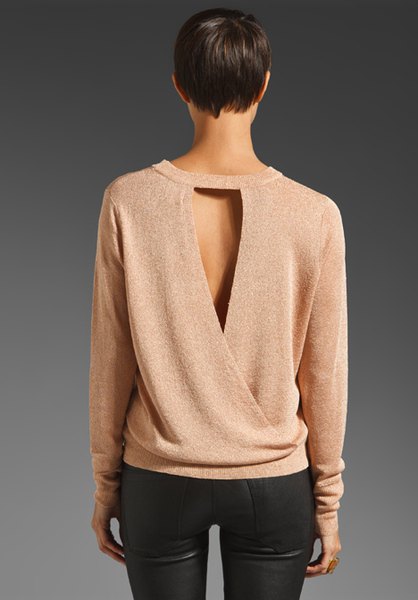 Light pink sweater with a cut out back and black skinny jeans