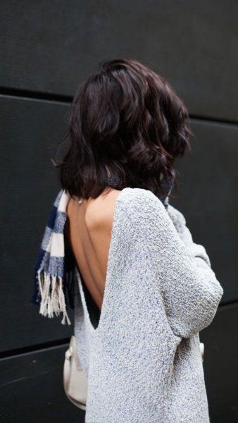 light mottled gray sweater with plaid scarf