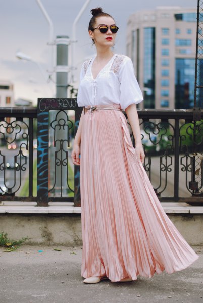 white short-sleeved V-neck blouse with light pink flowy skirt