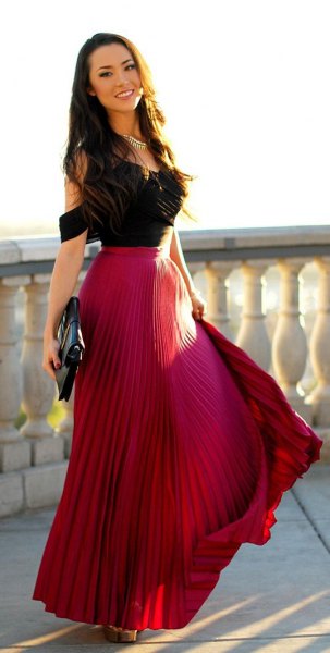black cold shoulder top with red pleated skirt