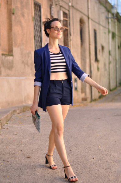 black and white striped crop top worn with a navy blue blazer and matching scalloped hem shorts