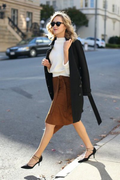white sweatshirt with black wool coat and brown knee length skirt