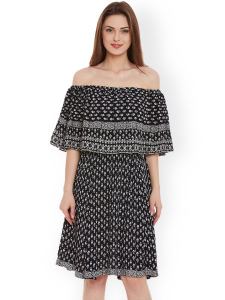 The shoulder-length, knee-length dress is printed in black and white tribal