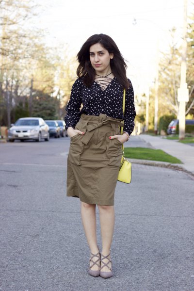 Black and white polka dot blouse with high green cargo skirt