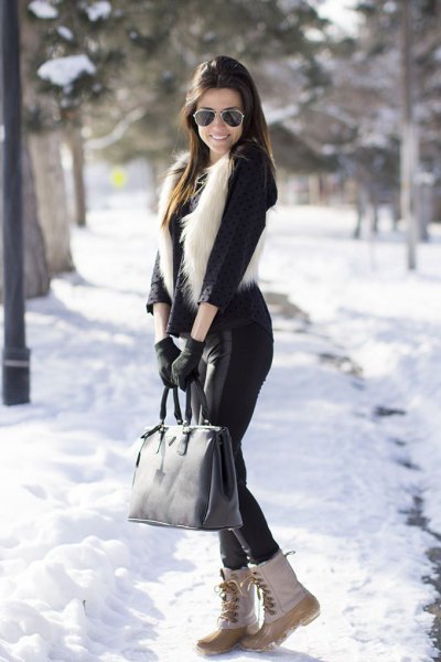 black blouse with faux fur vest and white snowshoes