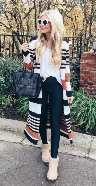 white t-shirt with multicolored striped longline coat and snowshoes