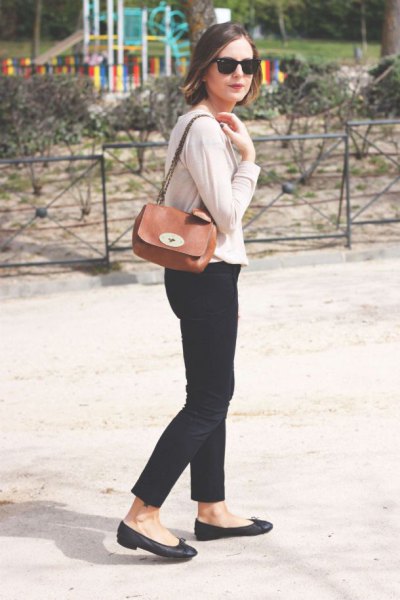 Ivory cardigan worn with black cropped jeans and a small brown shoulder bag