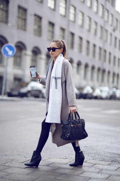 light gray wool coat with long white scarf and black leather wedge boots