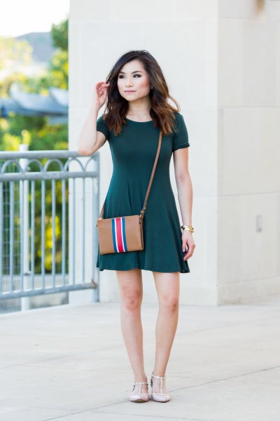 Short sleeve dark green mini skater dress with brown leather shoulder bag