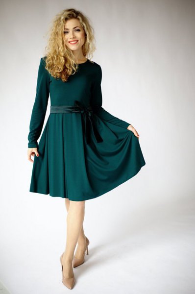 Long sleeved dark green fitted and flared midi dress with light pink heels
