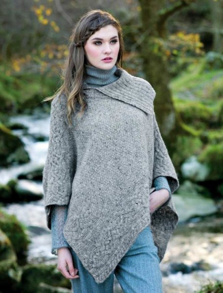 lightly mottled gray wool poncho over a ribbed knit sweater