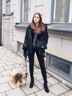black flight jacket with gray knit sweater and skinny jeans