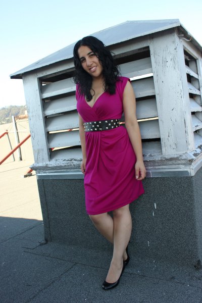 pink sleeveless knee-length sheath dress with black studded belt