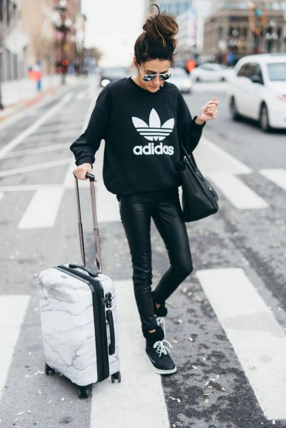 black graphic sweatshirt with leather leggings and sweater