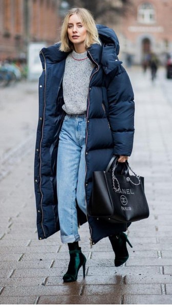 black long puffer coat with gray sweater and mom jeans