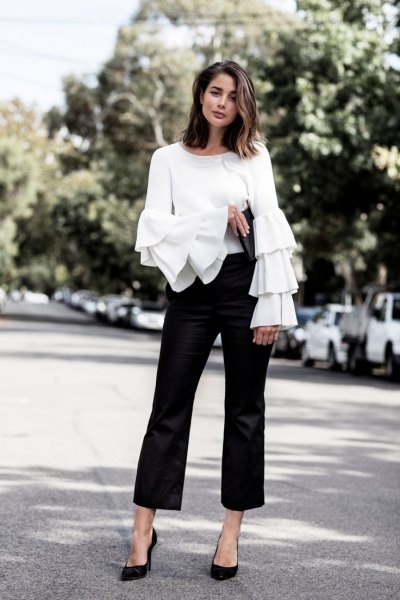 white top with ruffle sleeves, black dress pants