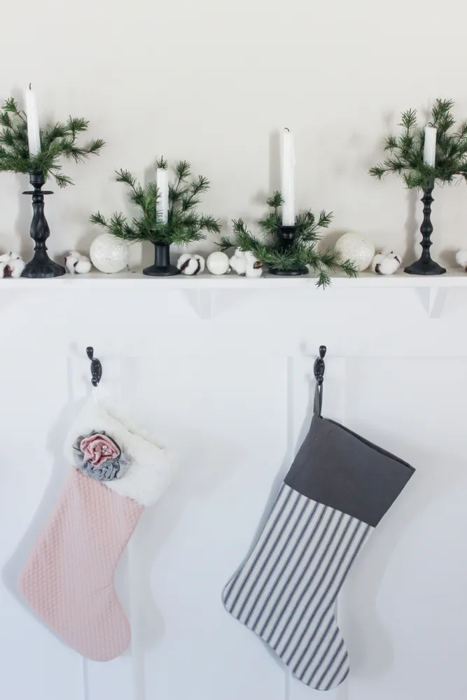 Black candlesticks with white pine branches
