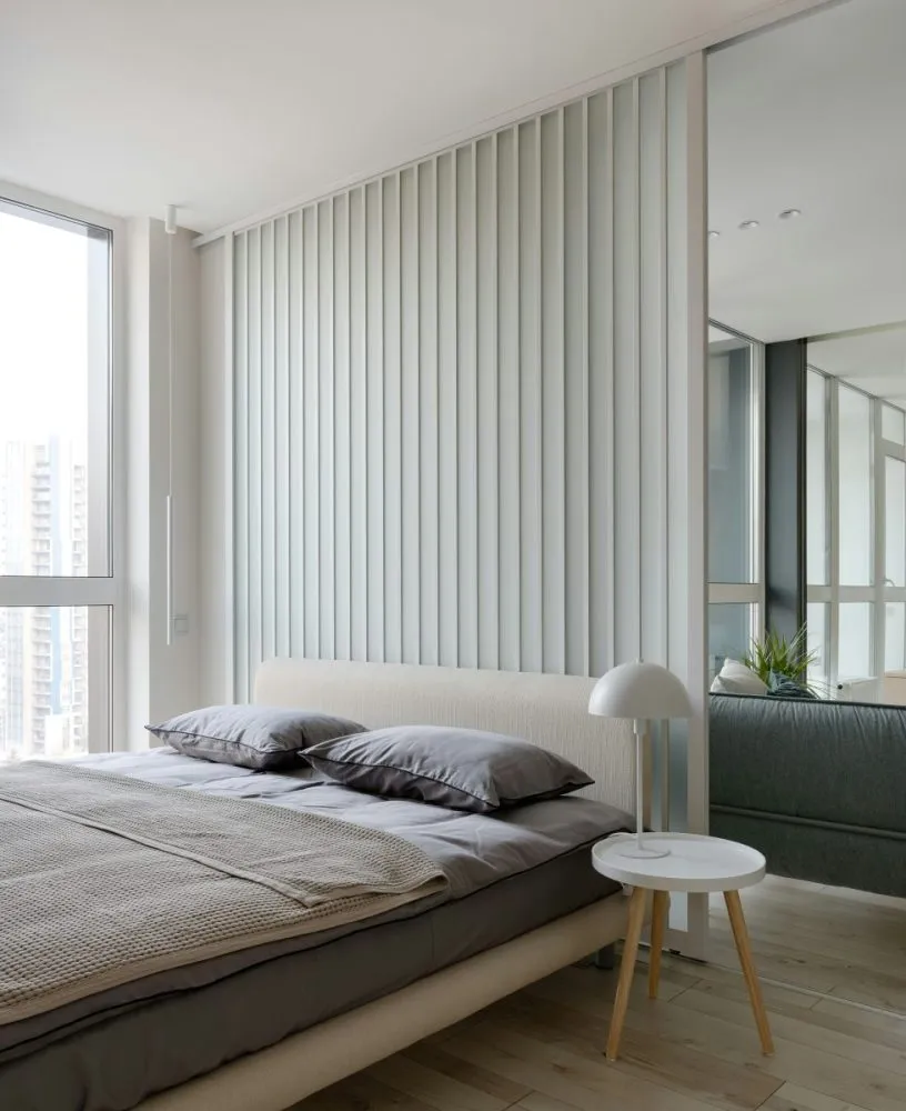 Bedroom with taupe headboard and gray bedding