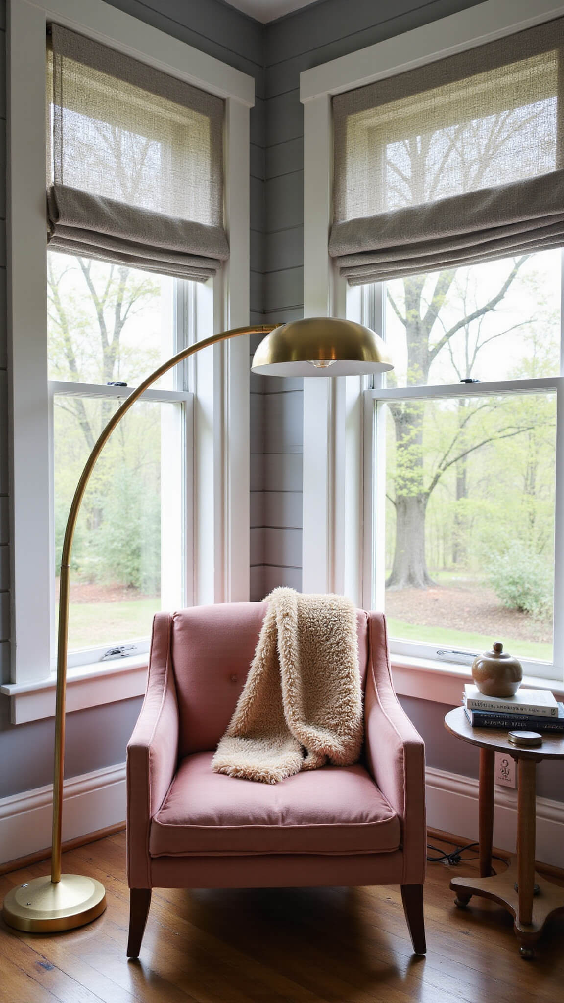 Cozy reading nook with dusty rose velvet armchair, layered curtains, brass floor lamp, ceramic side table, and a mohair throw bathed in morning light.