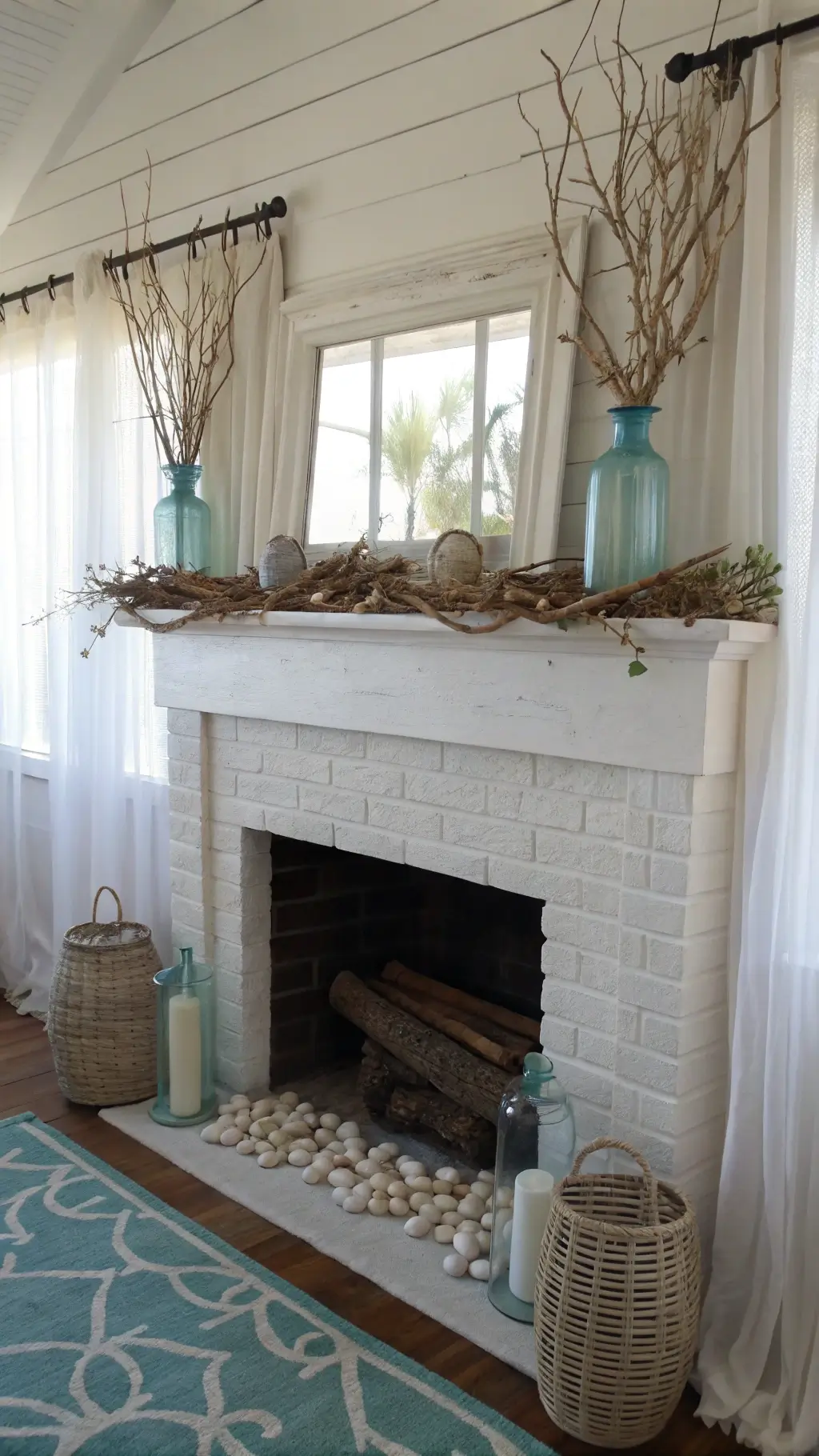 Coastal-inspired Easter mantel featuring driftwood garland, sea glass eggs, mercury glass vases, and mother of pearl frames in a bright beach cottage setting.