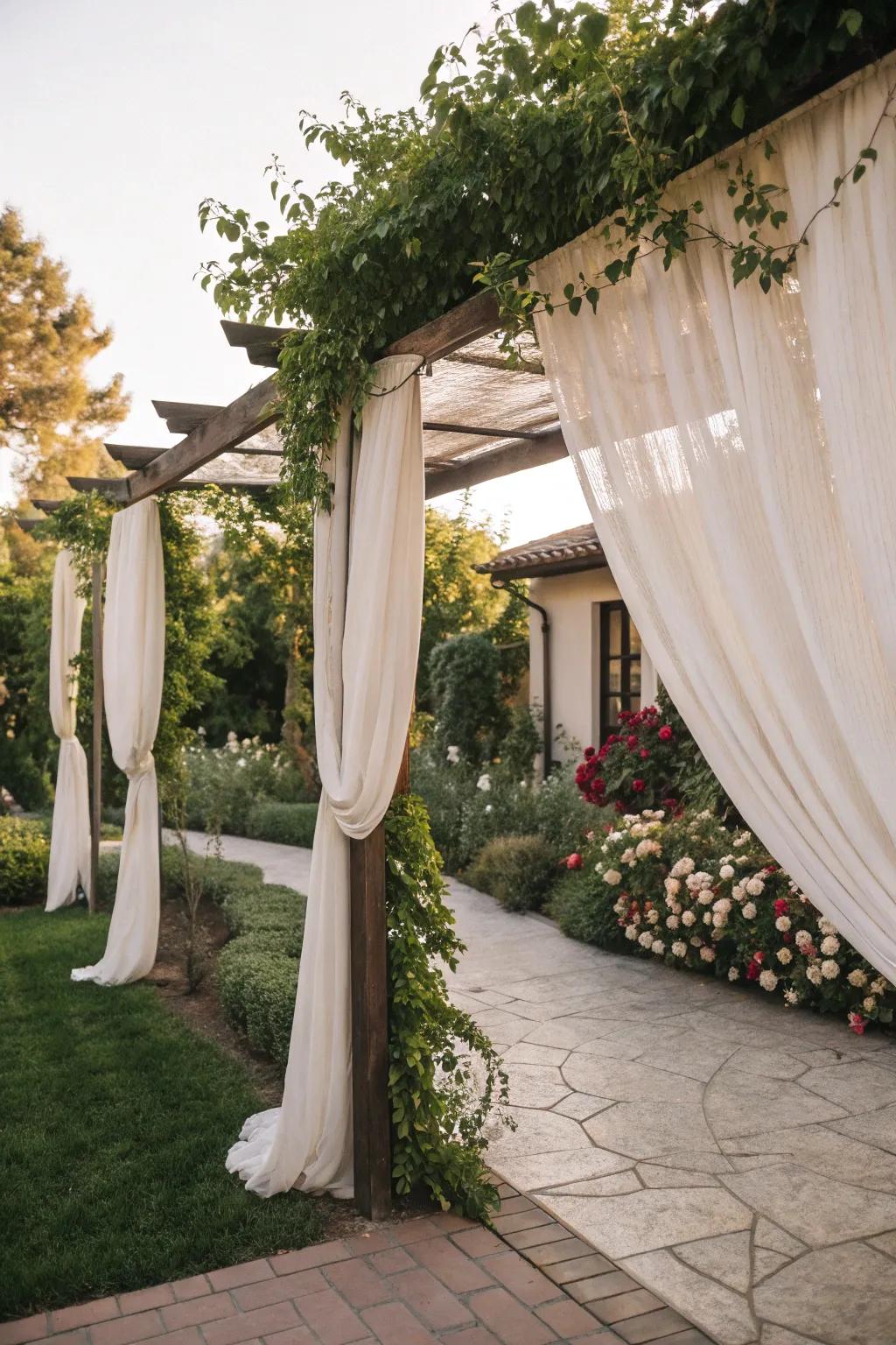 An arbor adorned with curtains for privacy and style.