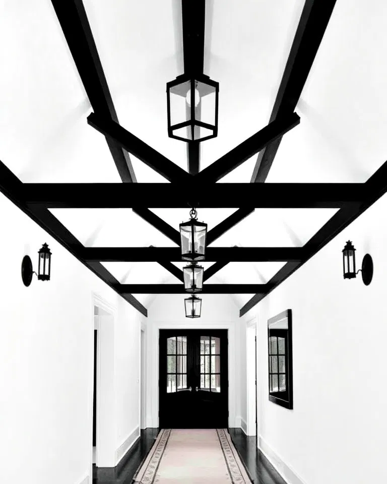 white hallway walls with black ceiling beams